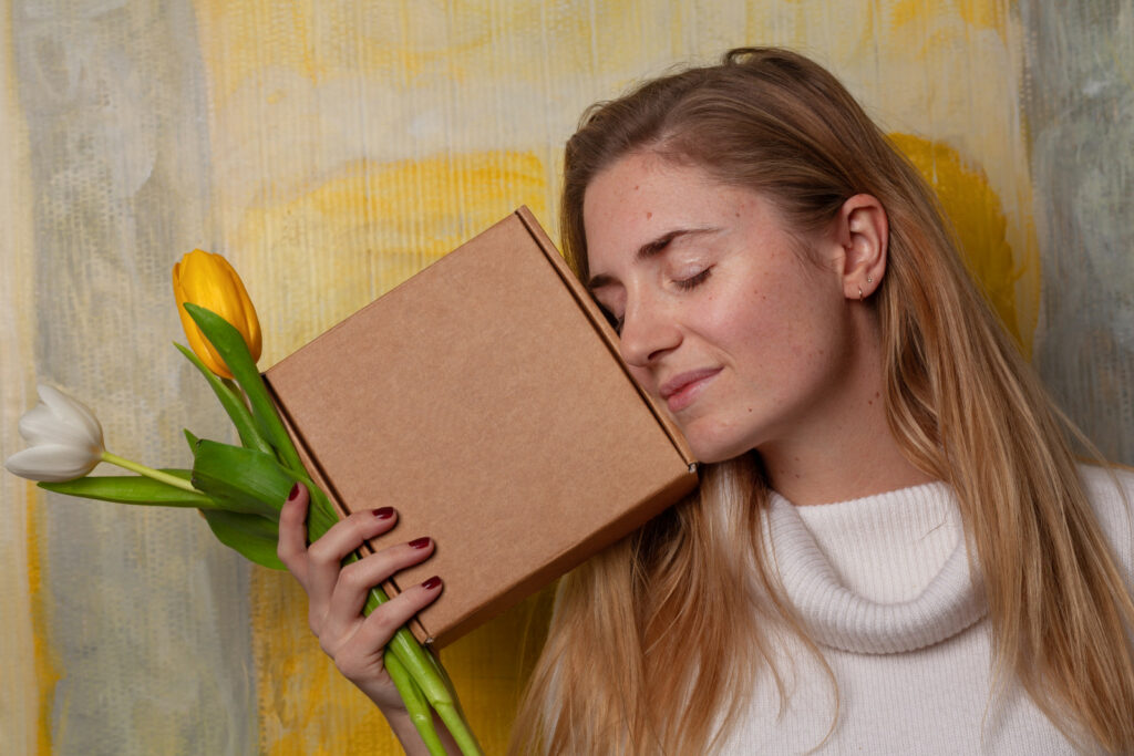 Young woman with sustainable cardboard packaging box