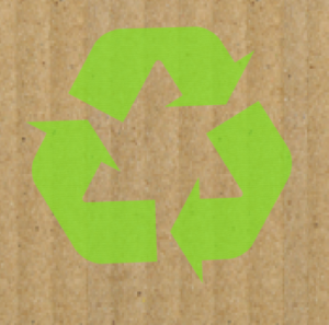Green recycle symbol over corrugated cardboard