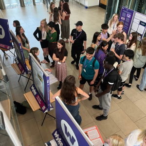 Students gathering around custom POS standees